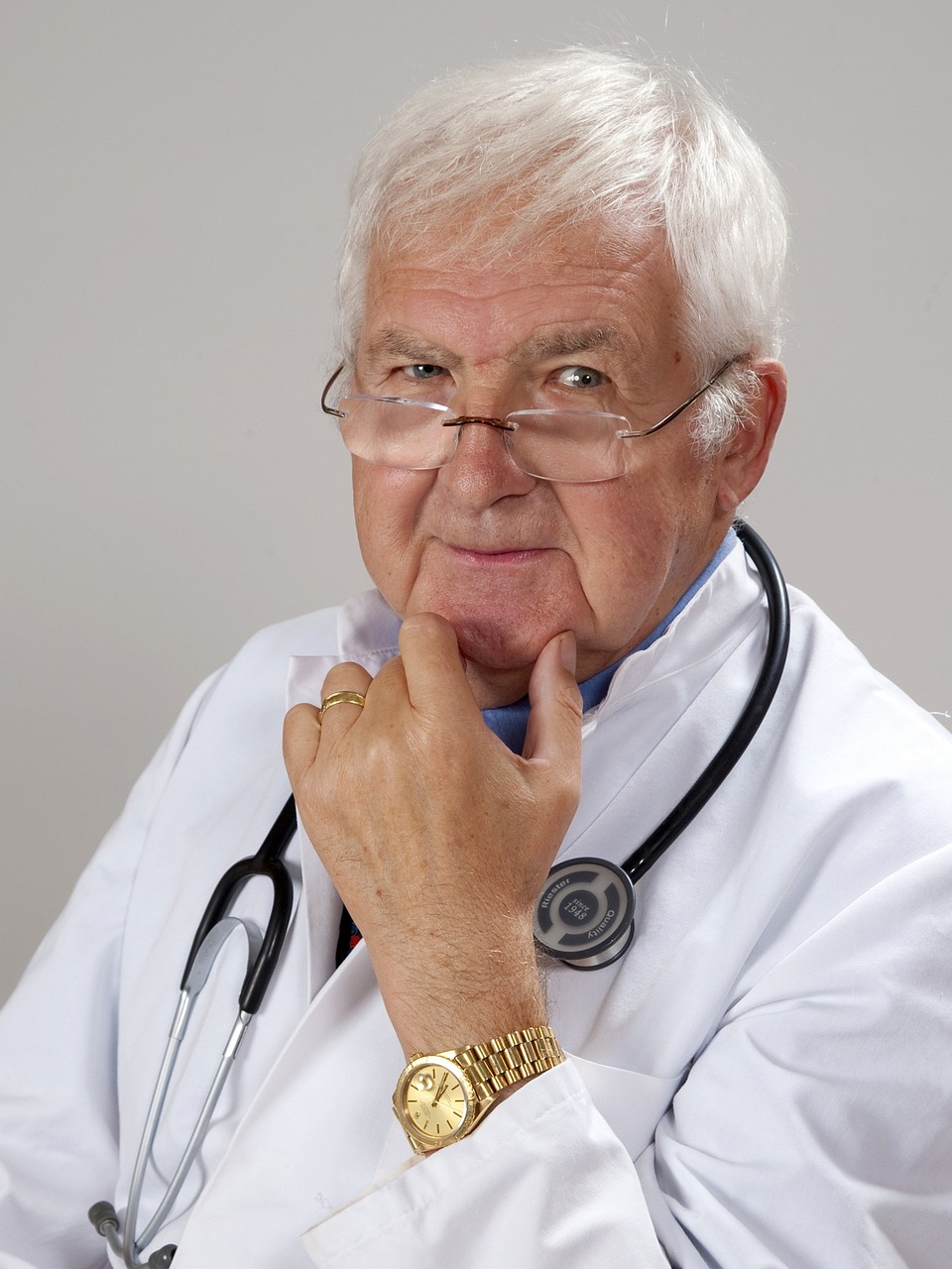 Experienced physician in a white lab coat with a stethoscope, representing healthcare professionals seeking medical equipment financing, medical practice acquisition loans, mental health practice loans, women's health clinic financing, and hospital funding programs to expand healthcare services, acquire practices, upgrade technology, and improve patient care.