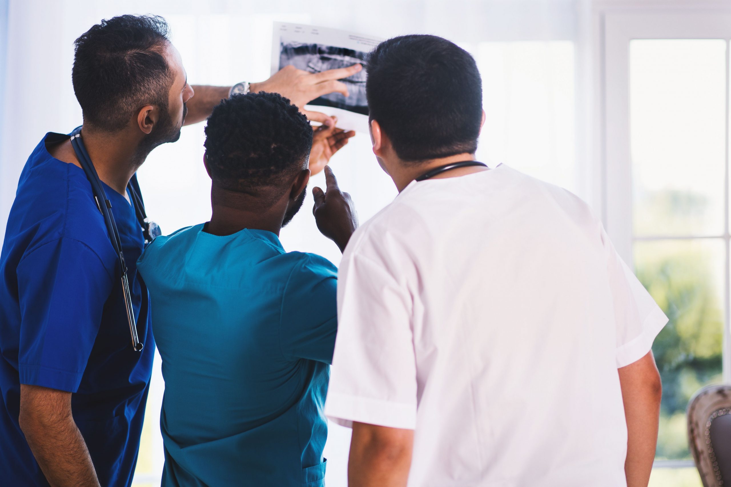 Healthcare professionals reviewing a medical image together in a clinical setting, representing hospital funding solutions, healthcare location expansion capital, medical receivables financing, rehabilitation clinic financing, and healthcare expansion lenders supporting growth, technology upgrades, and patient care improvements.