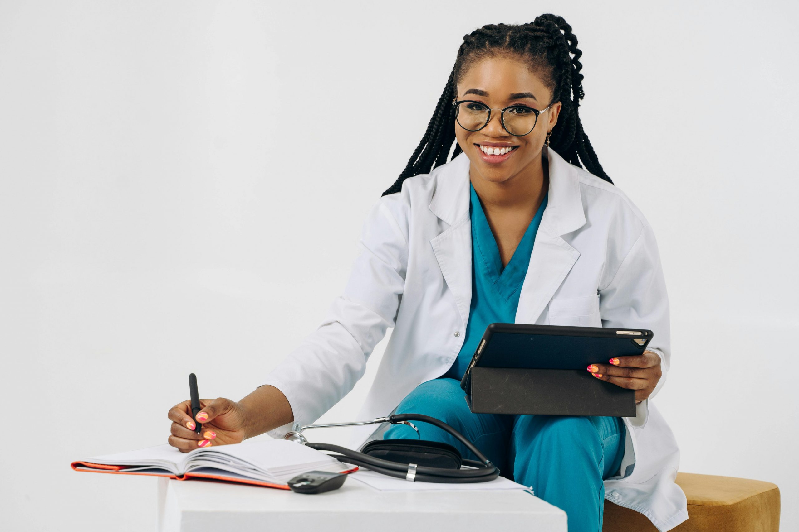 Healthcare professional reviewing patient records and using a tablet in a medical office, illustrating Truth in Lending, Doctor Business Loans, MRI Financing, Physician Financing Options, and Practice Management Software Financing for healthcare practice growth, equipment acquisition, and operational efficiency.