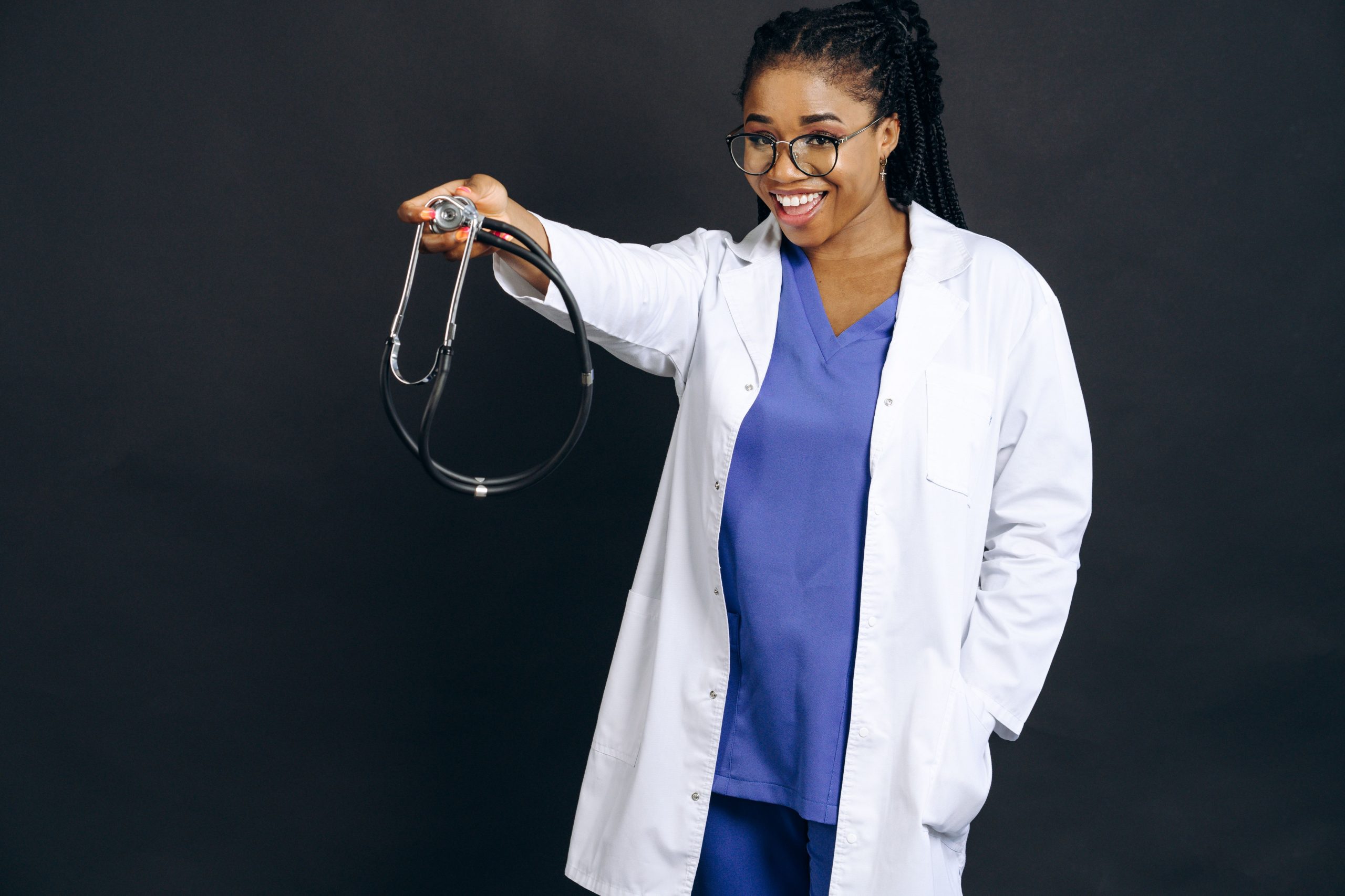 Female healthcare professional holding a stethoscope and smiling while representing Advertising Disclosure, Healthcare Lines of Credit, Business Line of Credit for Doctors, Medical Practice Line of Credit, and Healthcare Line of Credit solutions for physicians, medical practices, clinics, and healthcare providers seeking funding and working capital.