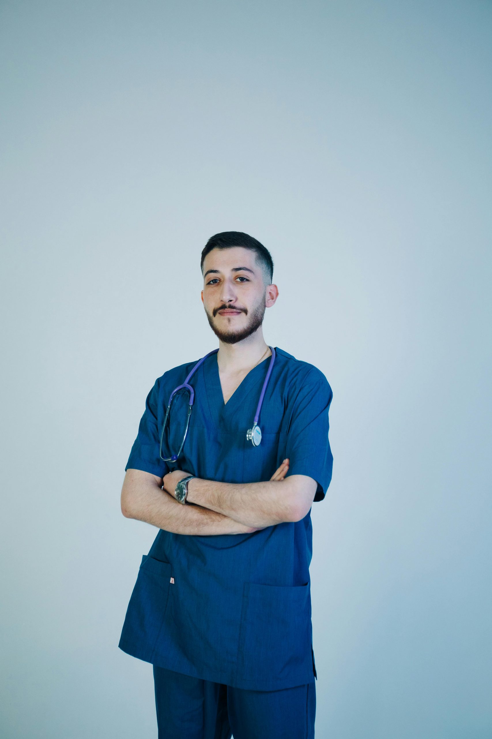 Healthcare professional standing confidently in blue medical scrubs with a stethoscope, representing providers seeking Healthcare business financing, learning how to finance a medical practice, investing in hospital digital transformation, securing wellness clinic financing, and obtaining healthcare renovation financing to expand services, modernize facilities, and improve patient care.