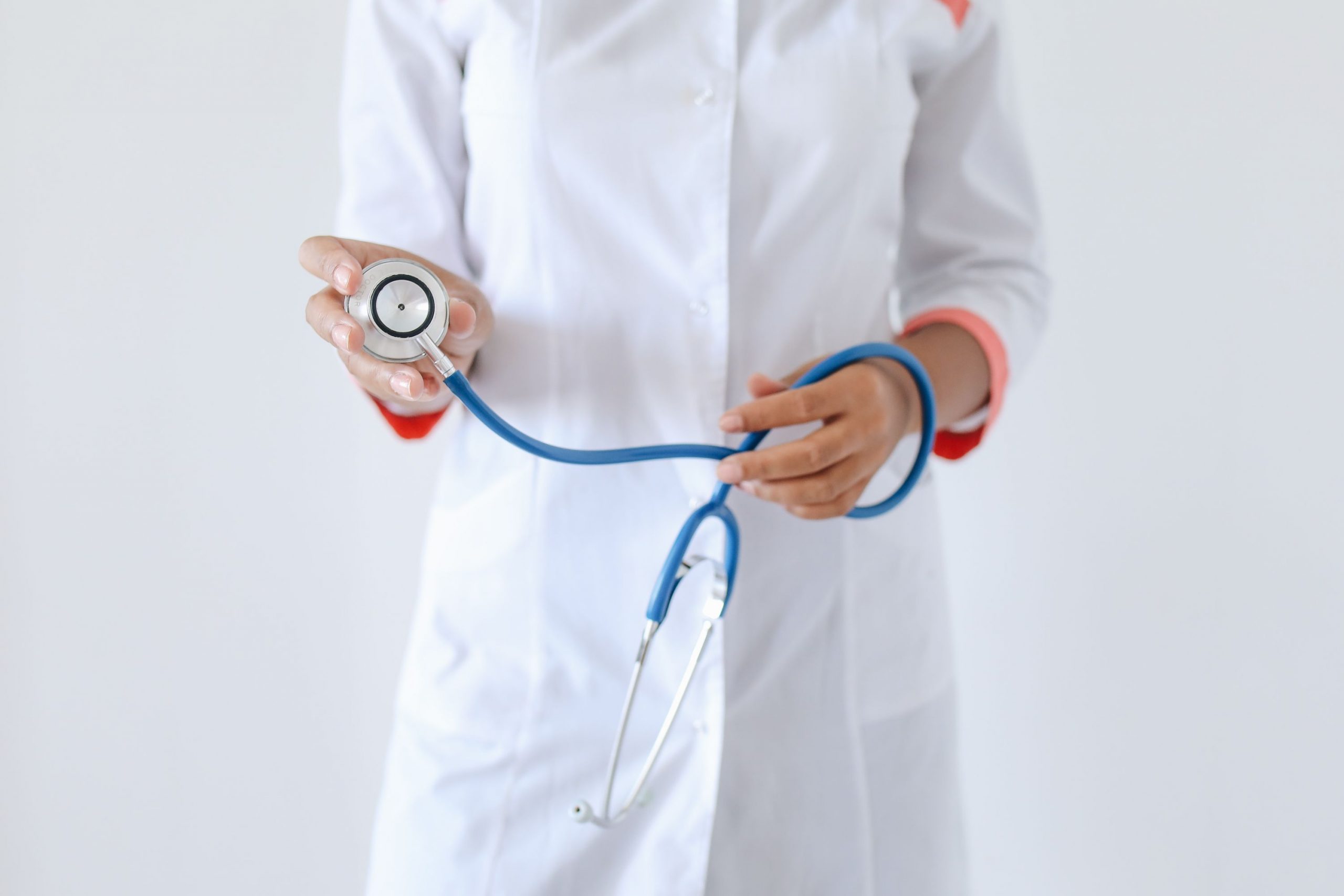 Healthcare professional holding a stethoscope, representing Terms and Conditions, Medical Equipment Loans, Practice Cash Flow Loans, Clinic Construction Financing, and Healthcare Development Financing for physicians, clinics, hospitals, and healthcare organizations seeking funding for equipment, facility expansion, construction projects, and operational growth.