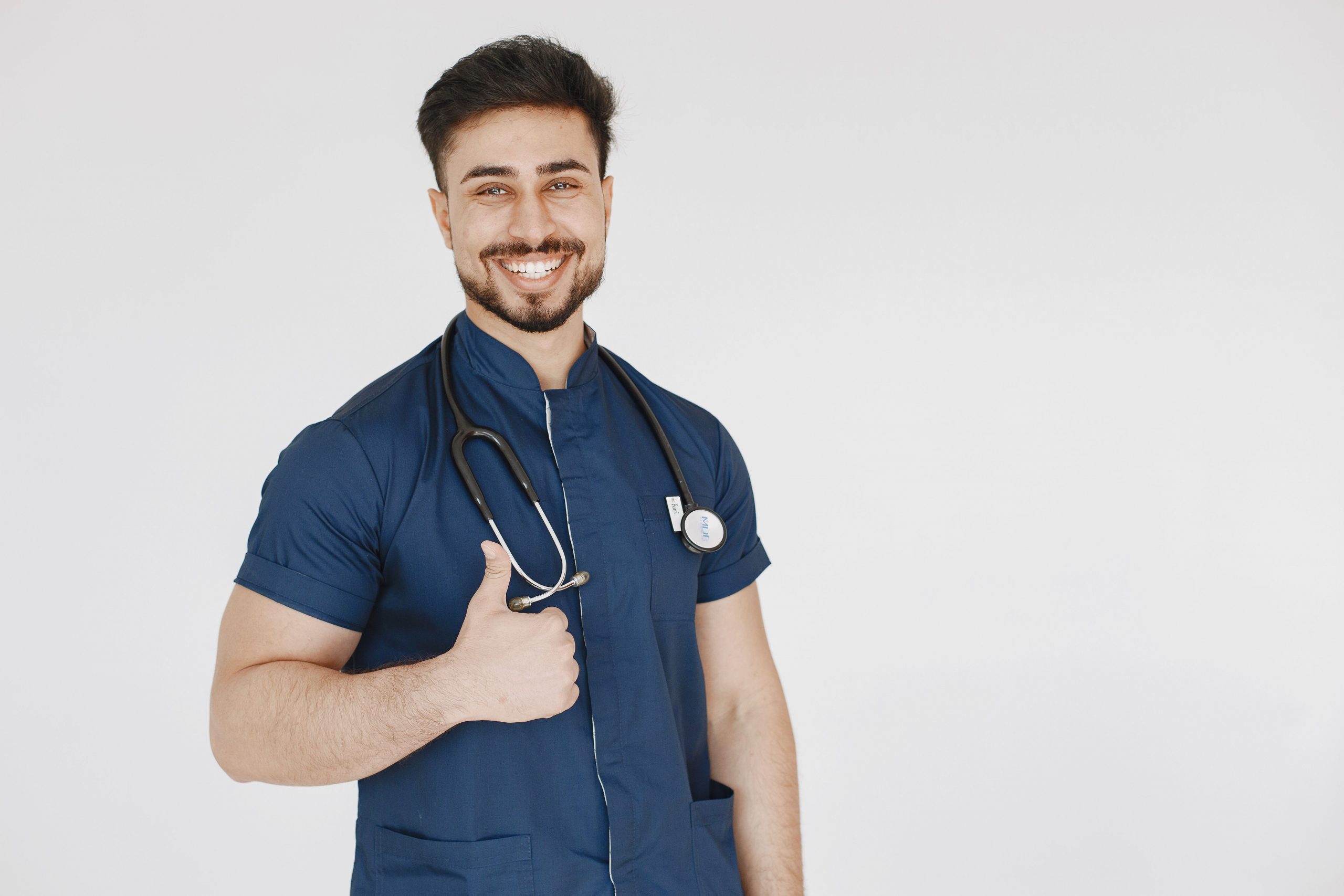 Smiling healthcare professional in medical scrubs with a stethoscope, representing Loans for Doctors, Hospital Revenue Bond Financing, Healthcare Business Loans, Diagnostic Equipment Financing, and Physical Therapy Clinic Financing for healthcare practice growth, facility expansion, equipment acquisition, and medical business development.