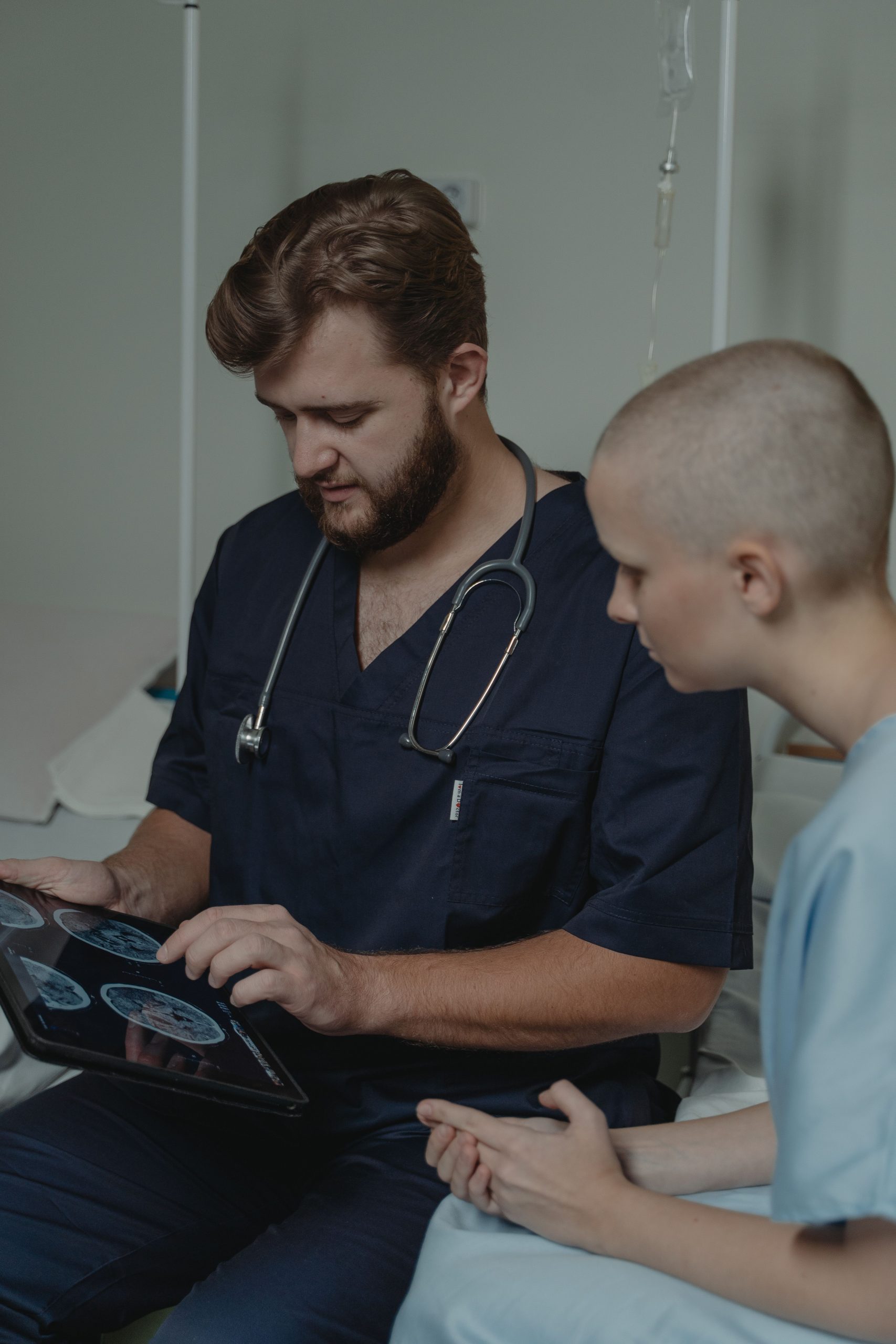 Healthcare professional reviewing diagnostic brain imaging with a patient during a clinical consultation, representing hospital operating capital, nonprofit hospital financing, hospital bond financing, healthcare operational funding, and healthcare system financing used to support advanced patient care, medical technology investments, facility operations, and long-term healthcare expansion.