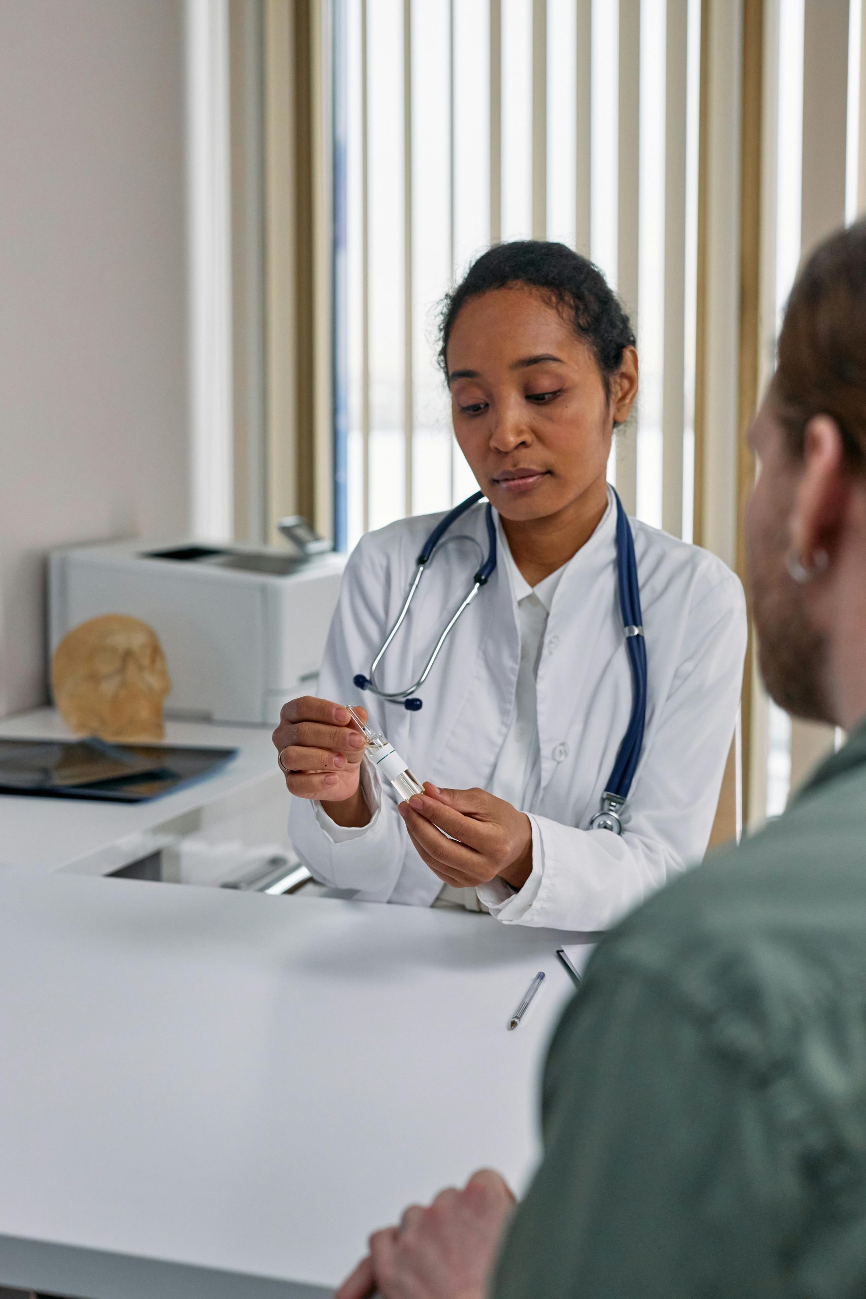Healthcare professional discussing treatment options with a patient during a medical consultation, representing healthcare facility upgrade funding, urgent care renovation financing, healthcare growth investors, patient care facility financing, and hospital digital transformation financing used to improve healthcare facilities, patient services, technology systems, and clinical operations.