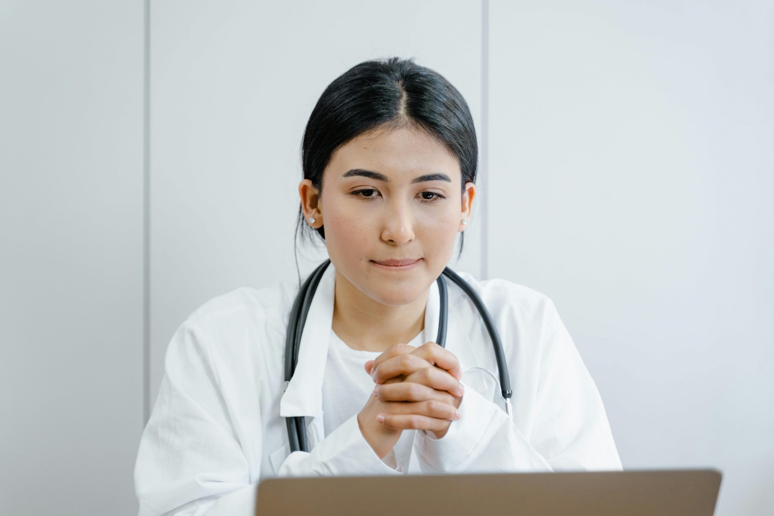Healthcare professional reviewing patient information in a modern medical office, representing X-Ray Equipment Financing, Medical Facility Construction Loans, Medical Practice Loans, Urgent Care Expansion Financing, and Financing a Medical Practice for healthcare growth, equipment acquisition, facility development, and practice expansion.